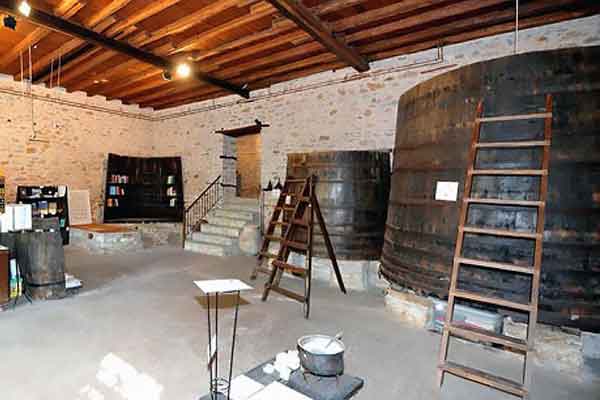 Interior of the Olive Museum with preserved vats and tools